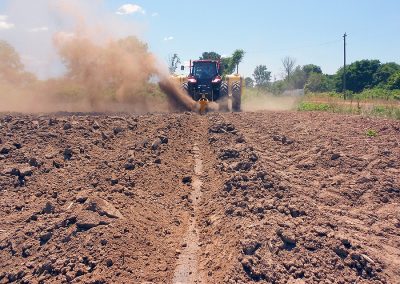 Ditcher in field digging trench