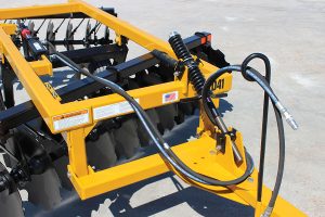 Closeup of D41 Wheel Offset Harrow tongue adjustment with hydraulic hoses