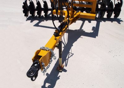 Closeup of J42 Wheel Offset Harrow adjustable tongue with chain and hydraulic hoses