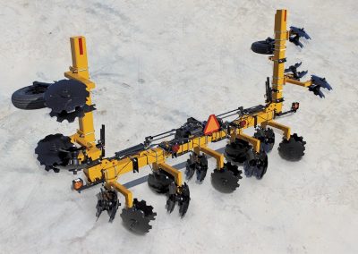 Aerial view of folded 8-row toolbar with bedding hipper assemblies