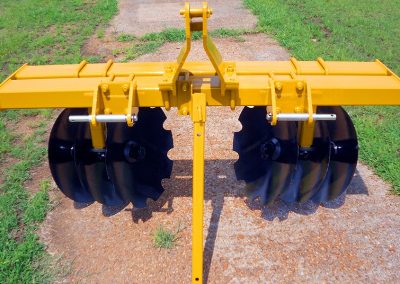 Full view of Border Plow folded on dirt and grass