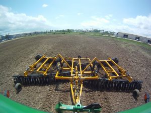 F15 Double Offset Tandem Disc Harrow being pulled behind tractor in the field