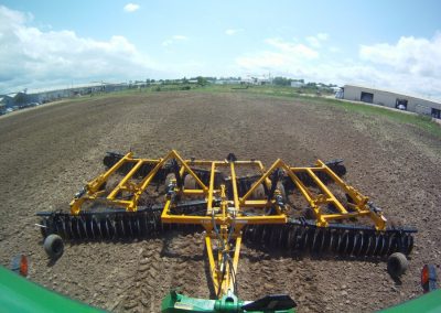 F15 Double Offset Tandem Disc Harrow being pulled behind tractor in the field