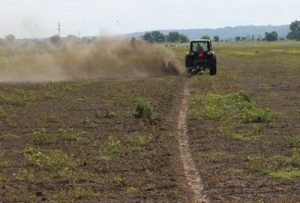 AMCO Offset Rotary Ditcher in the field