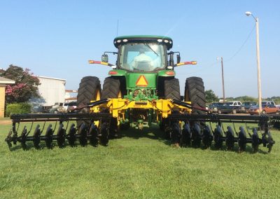 AMCO TJ3 Terracing Plow on green tractor unfolded