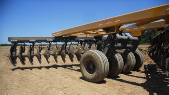 Closeup of back axles of G2 Wheel Offset Harrow in the field