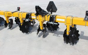 Closeup of 6-row toolbar with bedding hipper assemblies