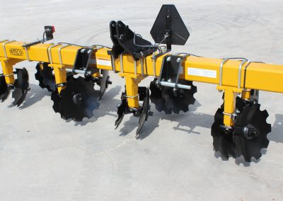 Closeup of 6-row toolbar with bedding hipper assemblies