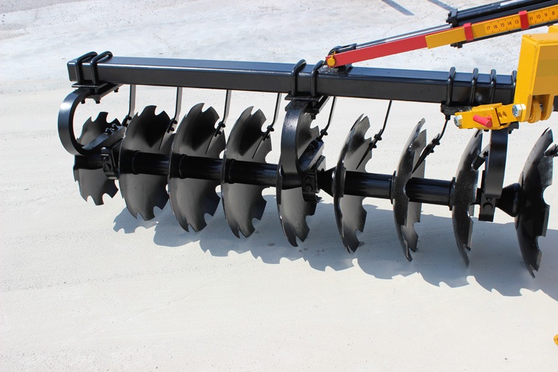 Closeup of Terracing Plow notched blades, with adjustable gangs and Shock Absorber Bearing Risers