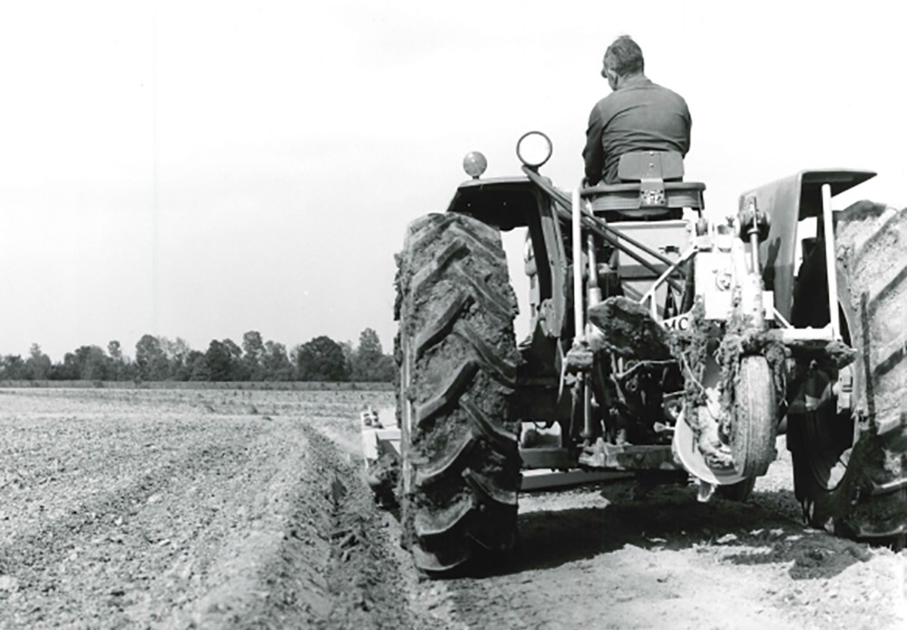 Black and white photo of farmer driving tractor