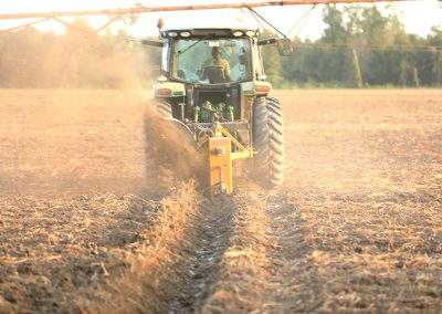 Full view of Dominator Vertical Rotary Ditcher in the field with tractor