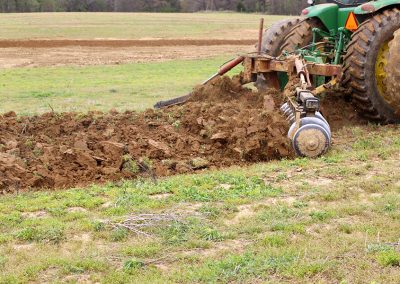 Closeup of AMCO TJ3 Terracing Plow running in the field