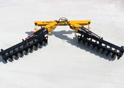 Overhead view of AMCO TJ3 Terracing Plow with parking stands on concrete