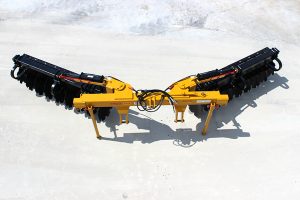 Overhead view of AMCO TJ3 Terracing Plow with parking stands on concrete