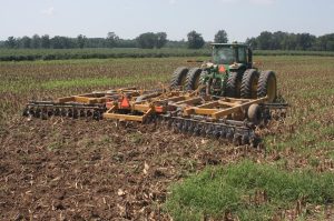 An AMCO F15 disc harrow prepares a field for planting.