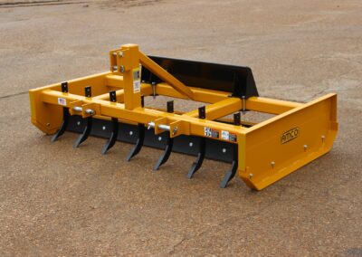 Front of Z-7 on the AMCO lot with skid steer universal adapter and scarifiers