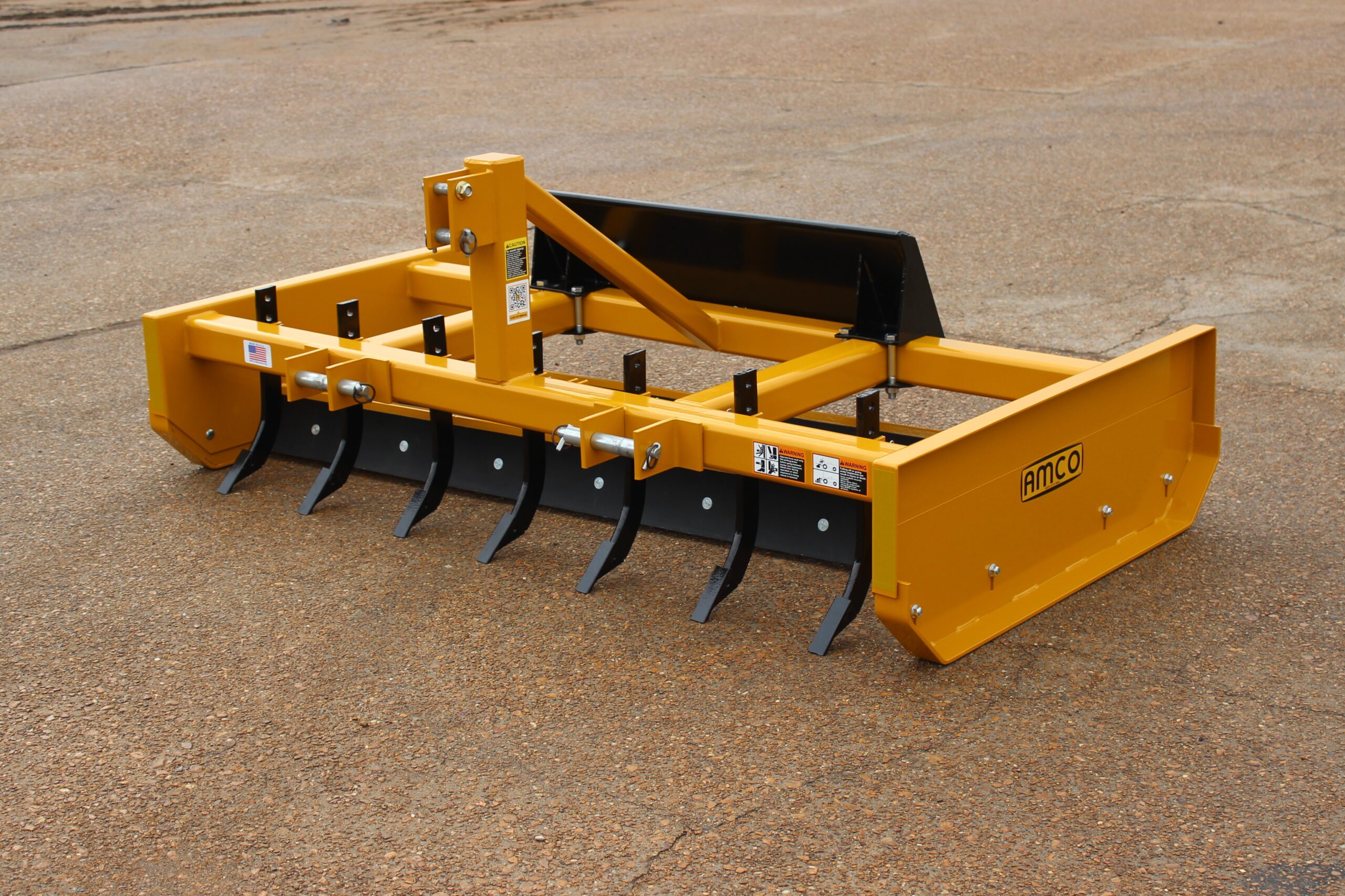 Front of Z-7 on the AMCO lot with skid steer universal adapter and scarifiers