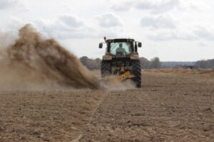 Rear view of Offset Rotary Ditcher digging a trench