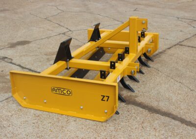 Side of Z-7 on the AMCO lot with skid steer universal adapter and scarifiers